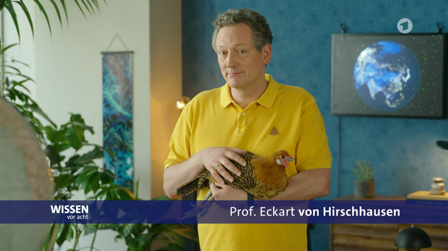 Prof. Eckart von Hirschhausen präsentiert ein Huhn der gefährdeten Rasse „Westfälische Totleger“ .