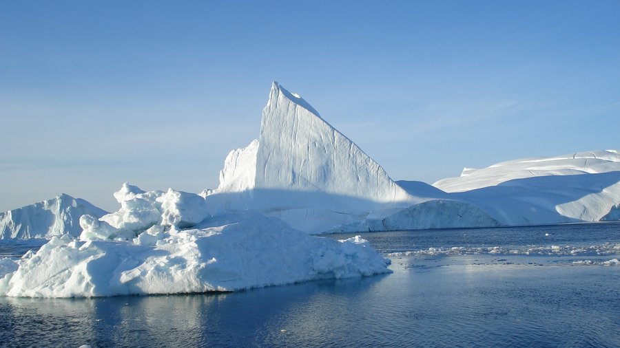 An iceberg against a blue sky